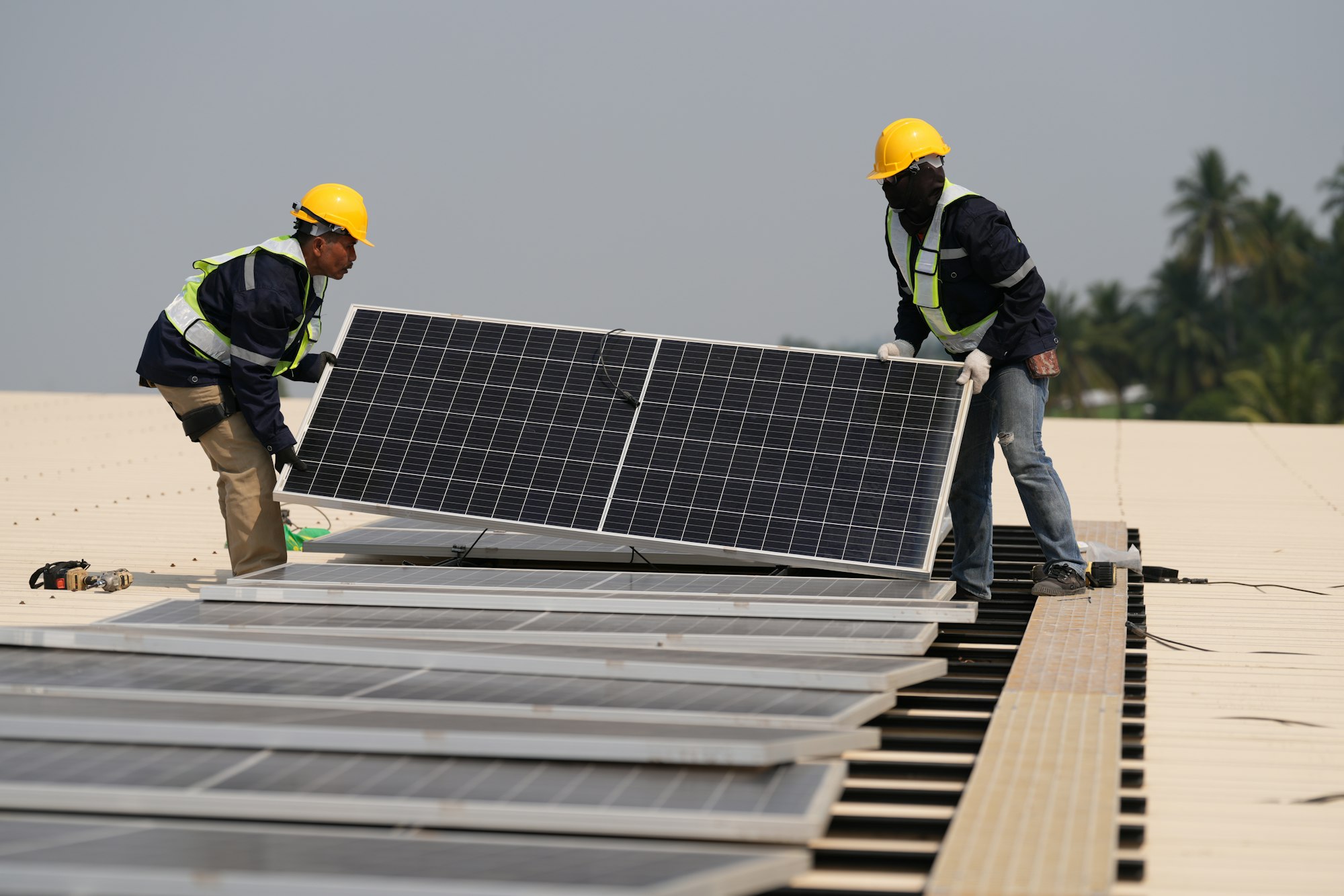 Engineer installing solar cell panels on roof.