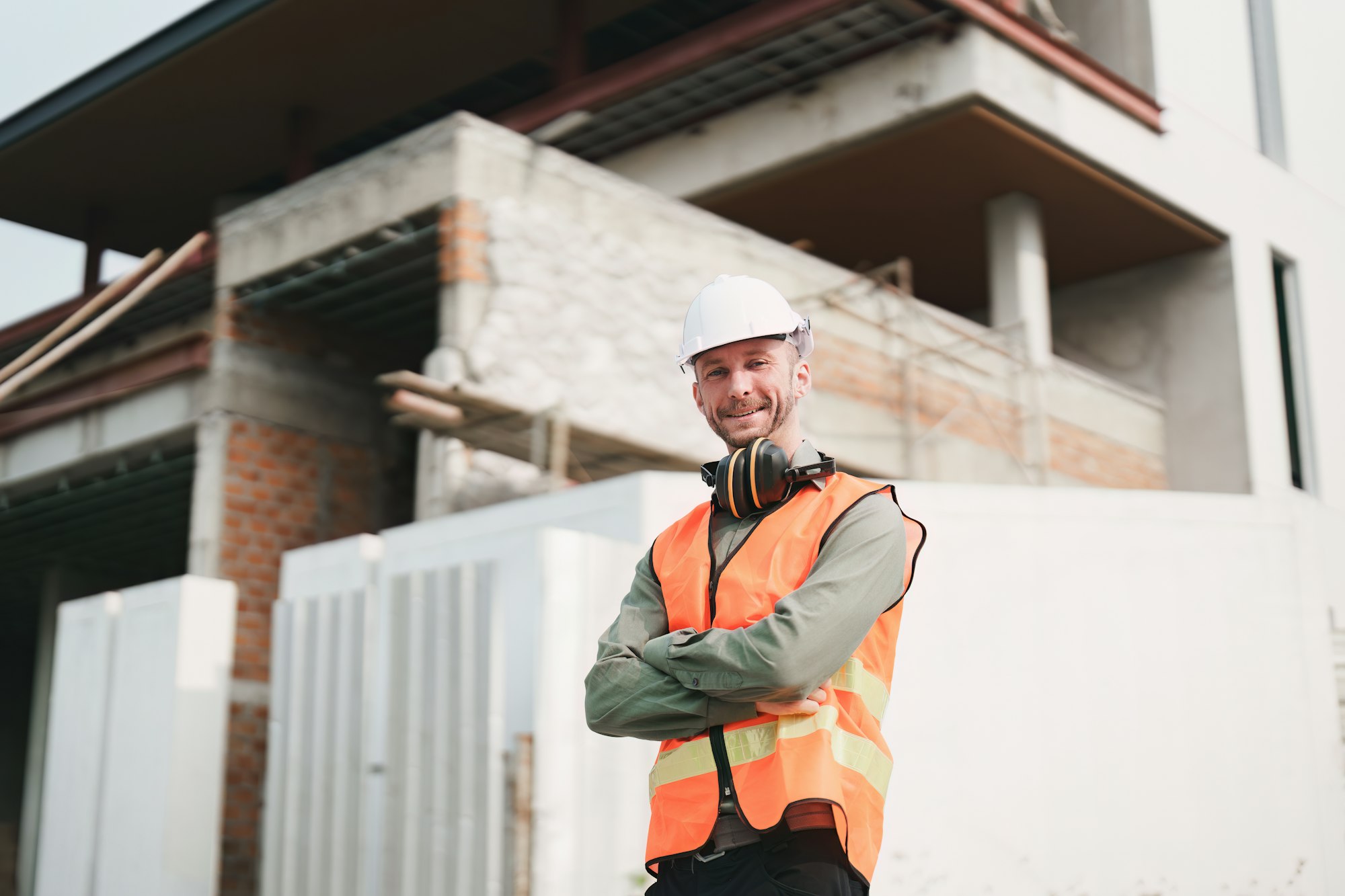 Foreman builder man at construction site. American foreman construction standing at construction