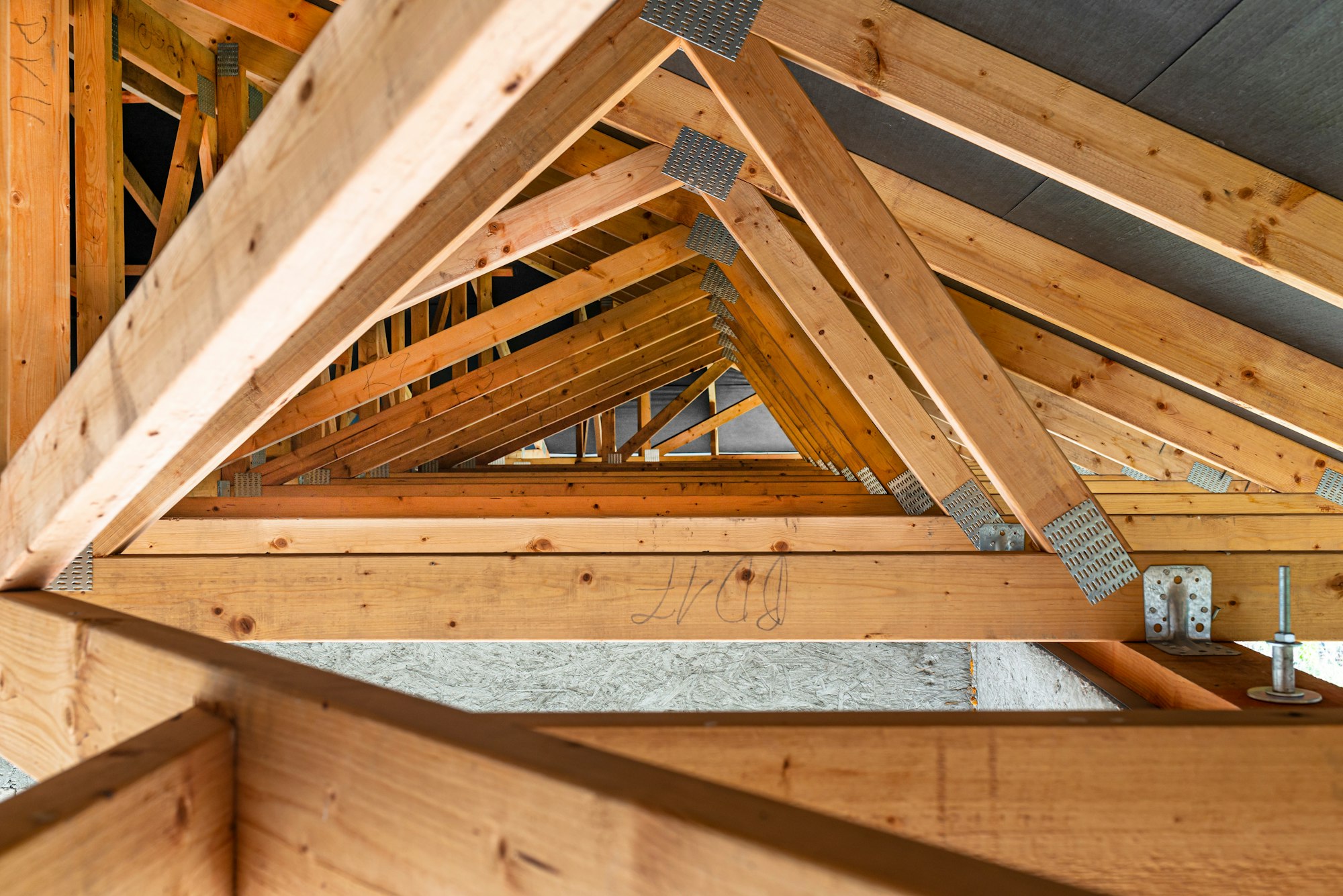 Roof trusses covered with a membrane on a detached house under construction,